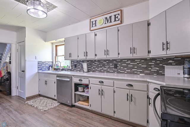 kitchen with dishwasher, black electric range oven, sink, tasteful backsplash, and light hardwood / wood-style floors