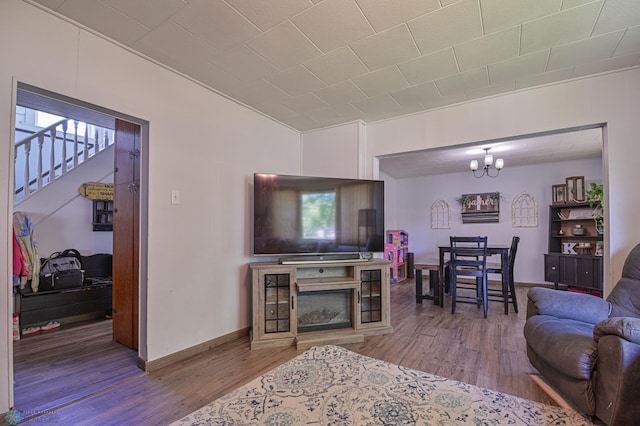 living room with an inviting chandelier and hardwood / wood-style flooring