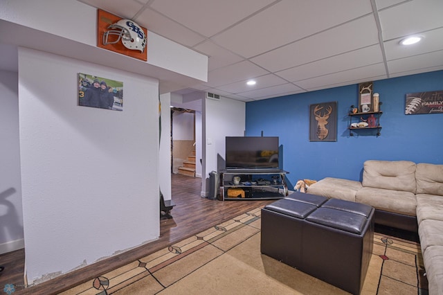 living room with wood-type flooring and a paneled ceiling