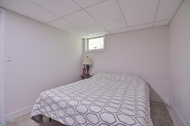 bedroom featuring carpet flooring and a paneled ceiling