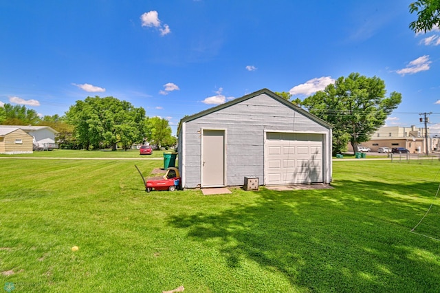 view of outbuilding with a lawn and a garage