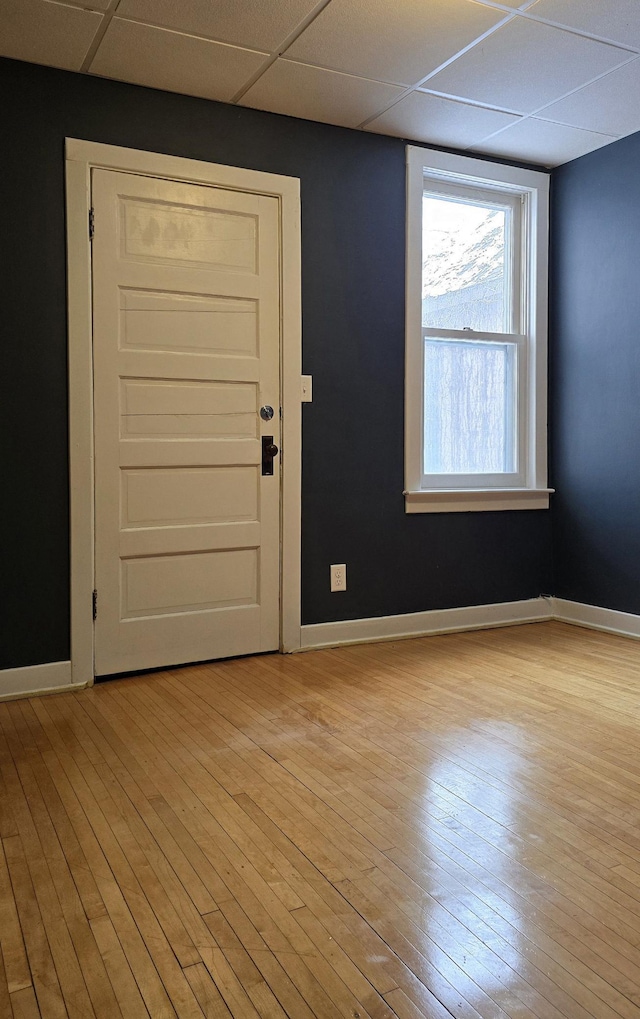 entryway with a drop ceiling and light hardwood / wood-style floors