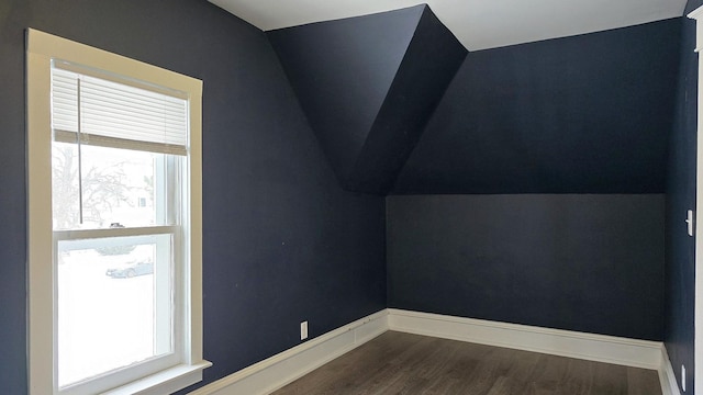 bonus room with hardwood / wood-style floors and vaulted ceiling