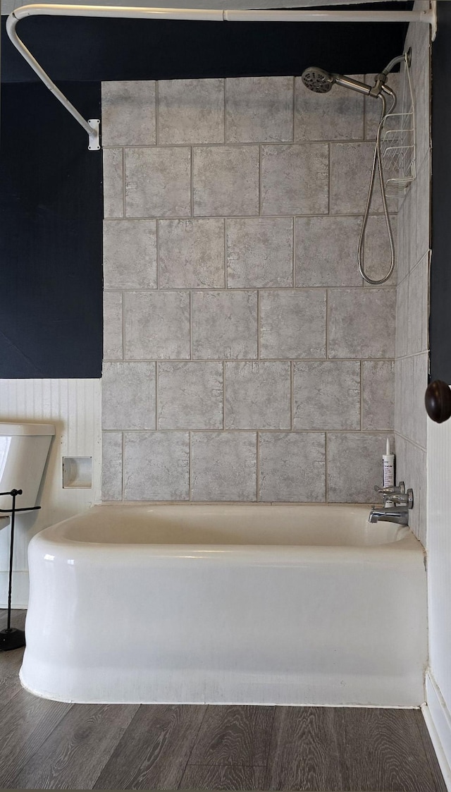 bathroom featuring tiled shower / bath combo and wood-type flooring