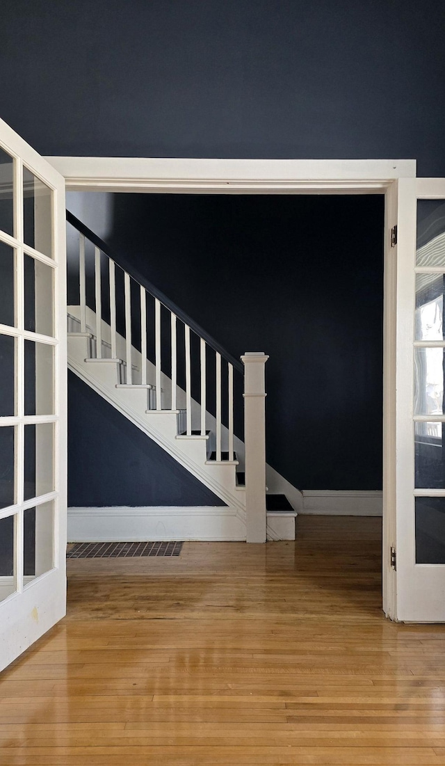 stairway featuring wood-type flooring