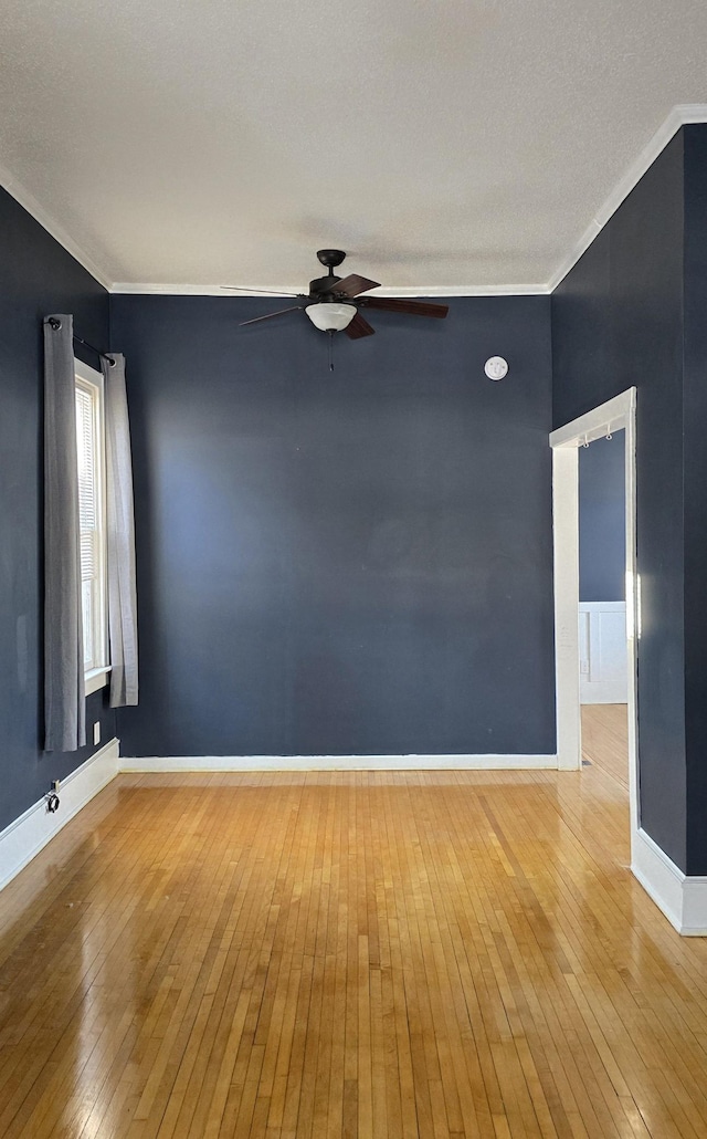 spare room featuring hardwood / wood-style floors and crown molding