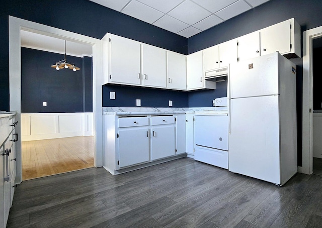 kitchen featuring pendant lighting, white appliances, white cabinets, range hood, and dark hardwood / wood-style flooring