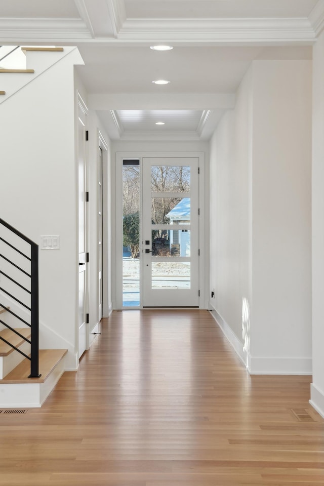 entryway featuring light wood-type flooring and ornamental molding