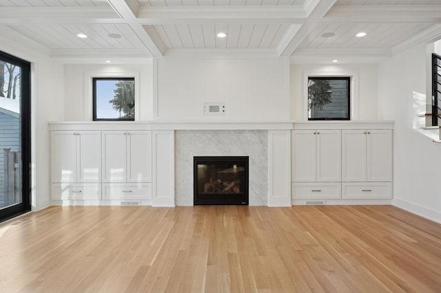 unfurnished living room featuring a fireplace, light hardwood / wood-style floors, crown molding, and beamed ceiling