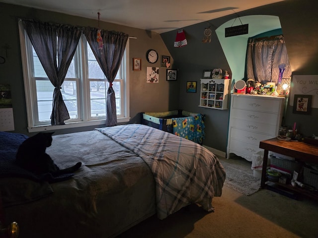 bedroom with carpet floors and lofted ceiling