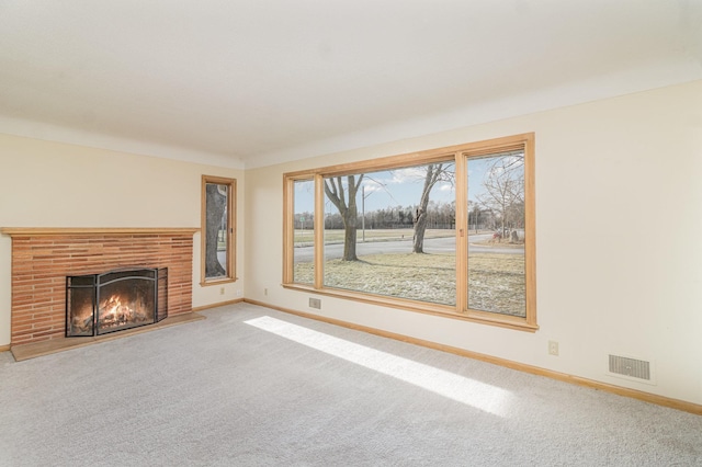 unfurnished living room featuring carpet flooring and a fireplace