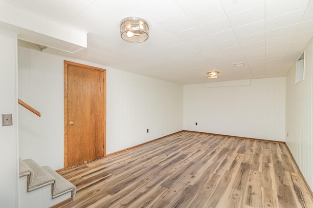 interior space featuring hardwood / wood-style floors and wooden walls