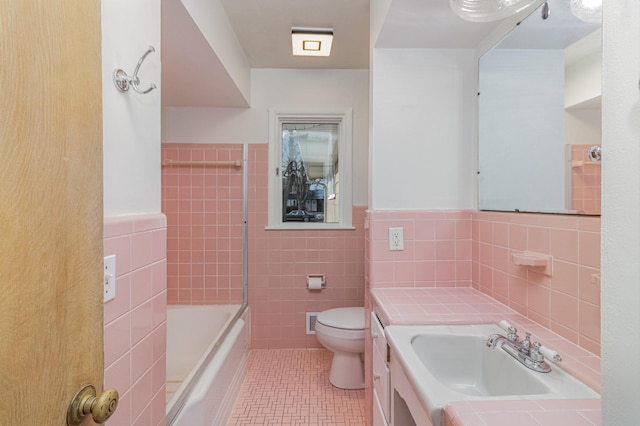 full bathroom with vanity, bathing tub / shower combination, toilet, and tile walls