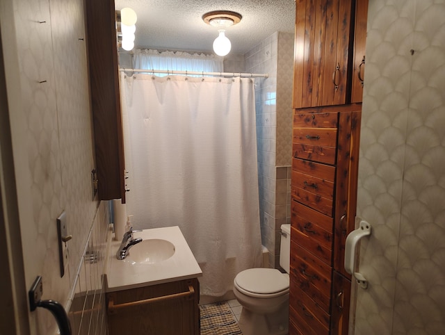 full bathroom with vanity, tile patterned flooring, shower / tub combo, a textured ceiling, and toilet