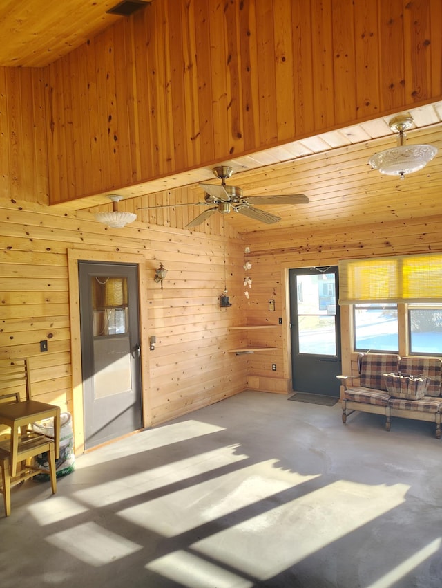 interior space with concrete floors and wood walls