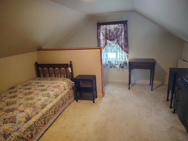 bedroom featuring baseboards, carpet floors, and vaulted ceiling