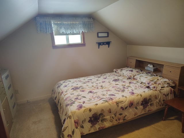 bedroom with light carpet, baseboards, and lofted ceiling