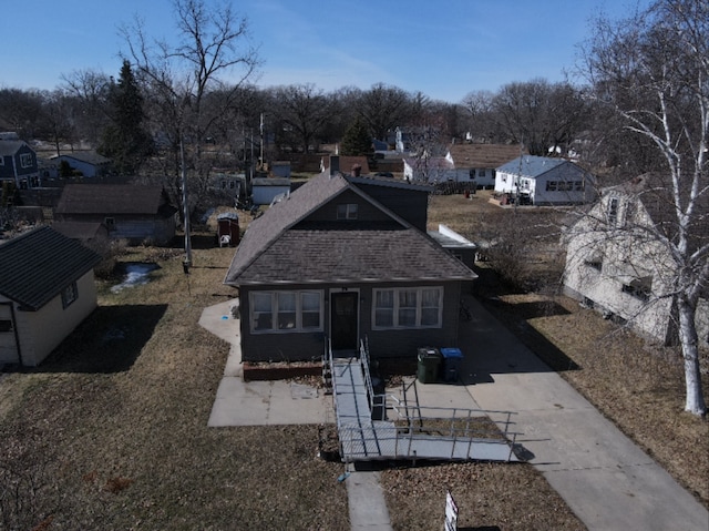 exterior space featuring a shingled roof