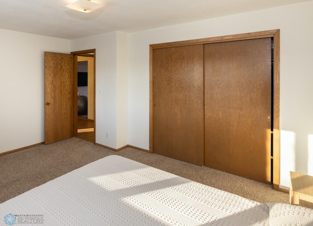 bedroom with light carpet and a closet