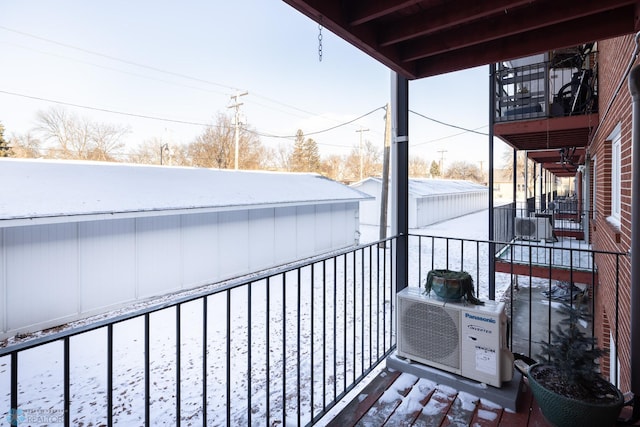 view of snow covered back of property