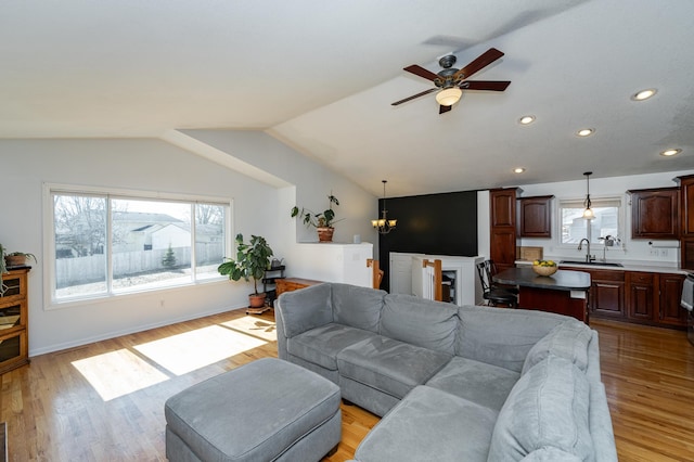 living room featuring baseboards, recessed lighting, ceiling fan, vaulted ceiling, and light wood-type flooring