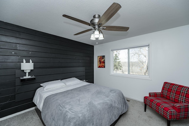 carpeted bedroom with a textured ceiling and a ceiling fan