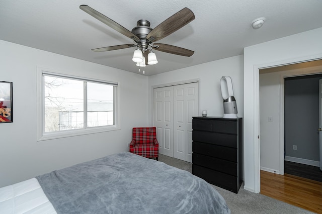 bedroom featuring a closet, baseboards, and ceiling fan