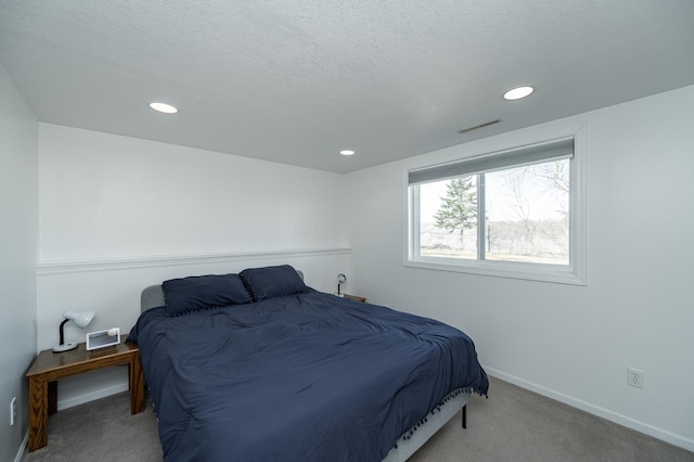 bedroom with visible vents, baseboards, recessed lighting, a textured ceiling, and carpet flooring