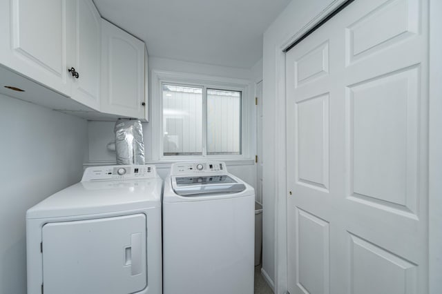 clothes washing area with cabinet space and independent washer and dryer