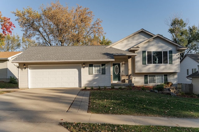 split level home featuring a garage, roof with shingles, concrete driveway, and a front lawn