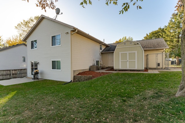 back of house featuring an outbuilding, a storage shed, a patio, and fence