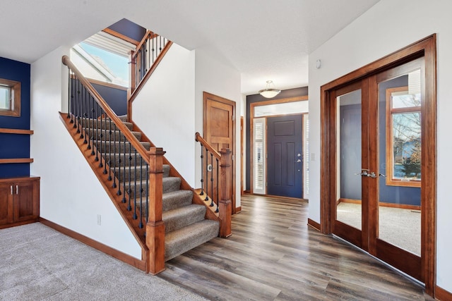 foyer with hardwood / wood-style floors and plenty of natural light