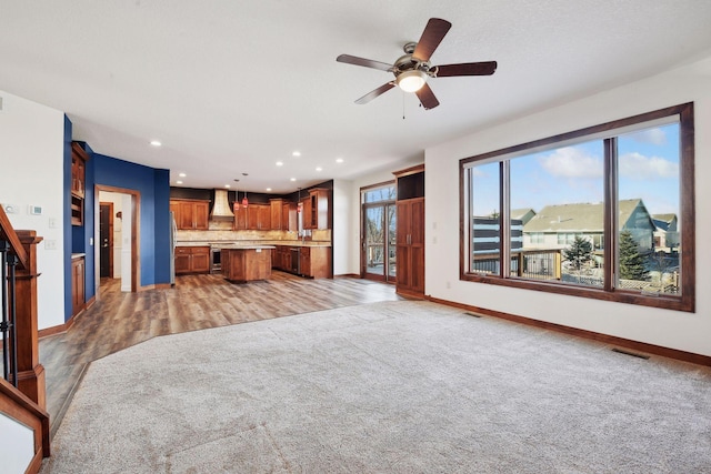 living room with ceiling fan and light wood-type flooring