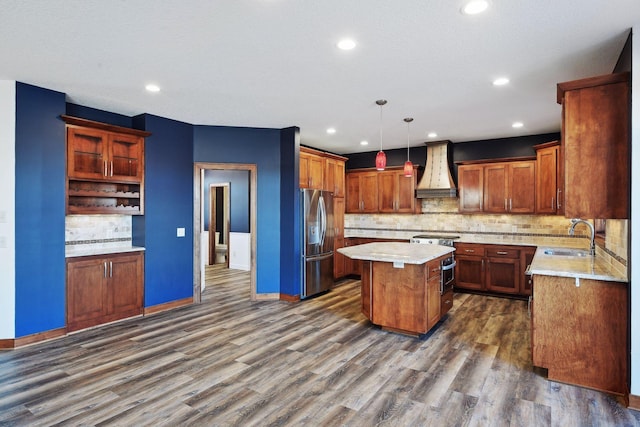 kitchen featuring a center island, hanging light fixtures, stainless steel appliances, dark wood-type flooring, and premium range hood