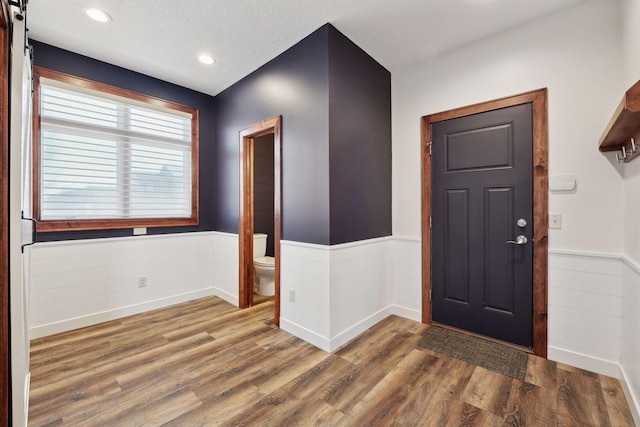 entryway with a barn door and dark hardwood / wood-style floors