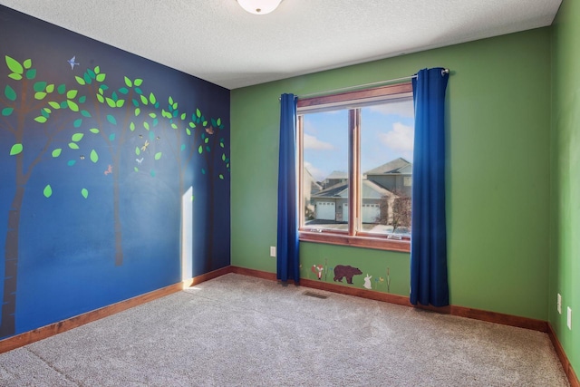 spare room with carpet floors and a textured ceiling