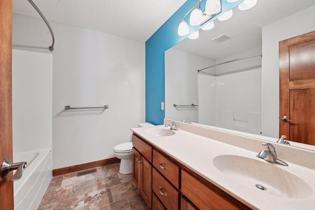 full bathroom featuring vanity, toilet, washtub / shower combination, and a textured ceiling