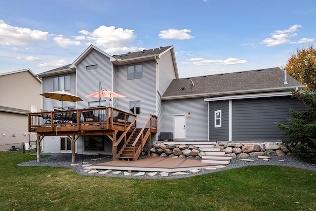 back of house featuring a deck and a yard