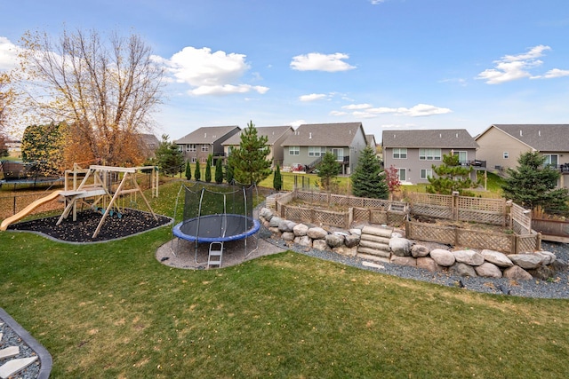 view of yard with a playground and a trampoline