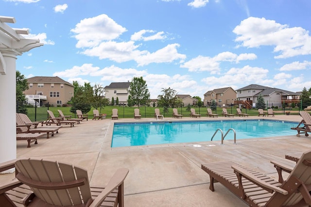 view of swimming pool featuring a lawn and a patio area