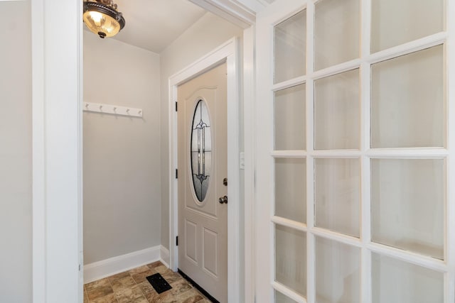 entryway featuring baseboards