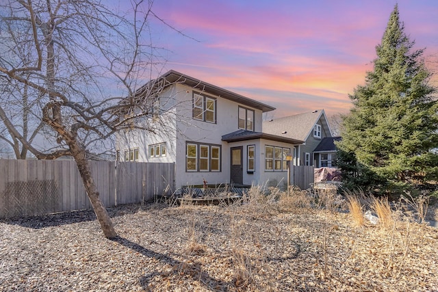 view of front of home featuring fence and stucco siding