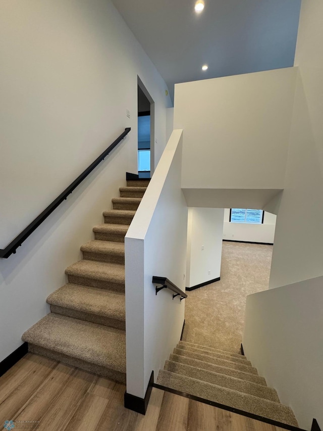 staircase featuring wood-type flooring