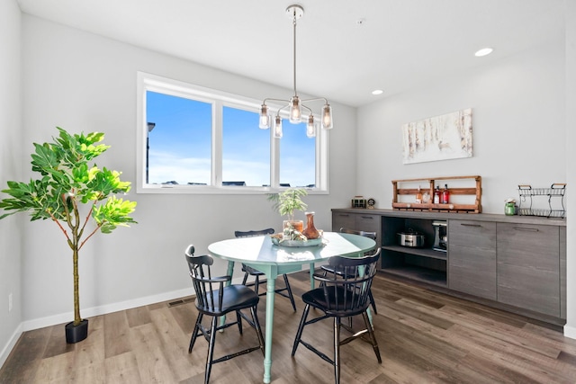 dining space with light wood-style flooring, baseboards, a chandelier, and recessed lighting