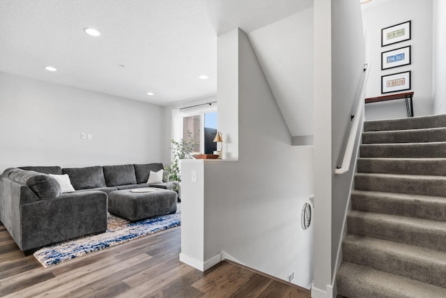 interior space with recessed lighting, wood finished floors, baseboards, and stairs