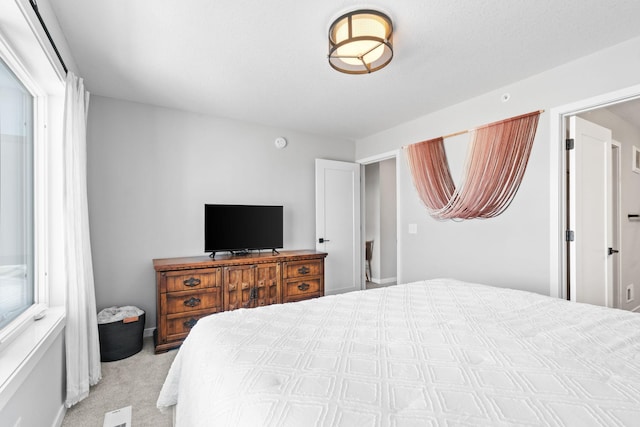 bedroom featuring light carpet