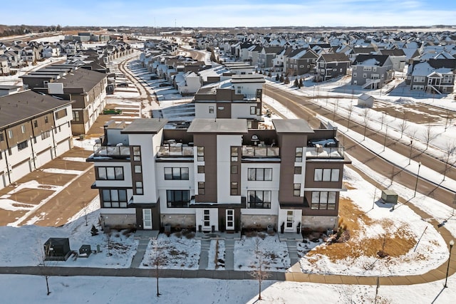 snowy aerial view featuring a residential view