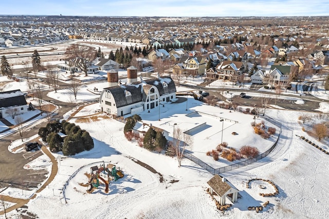 snowy aerial view with a residential view