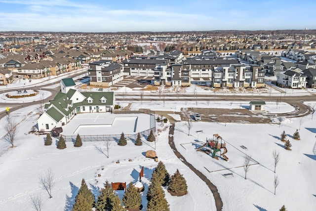 snowy aerial view featuring a residential view