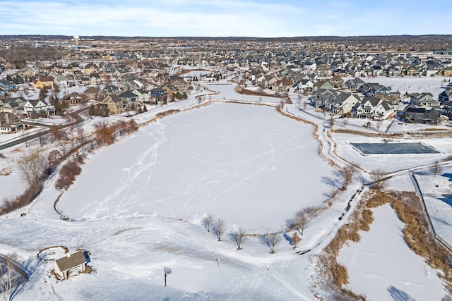 snowy aerial view with a residential view